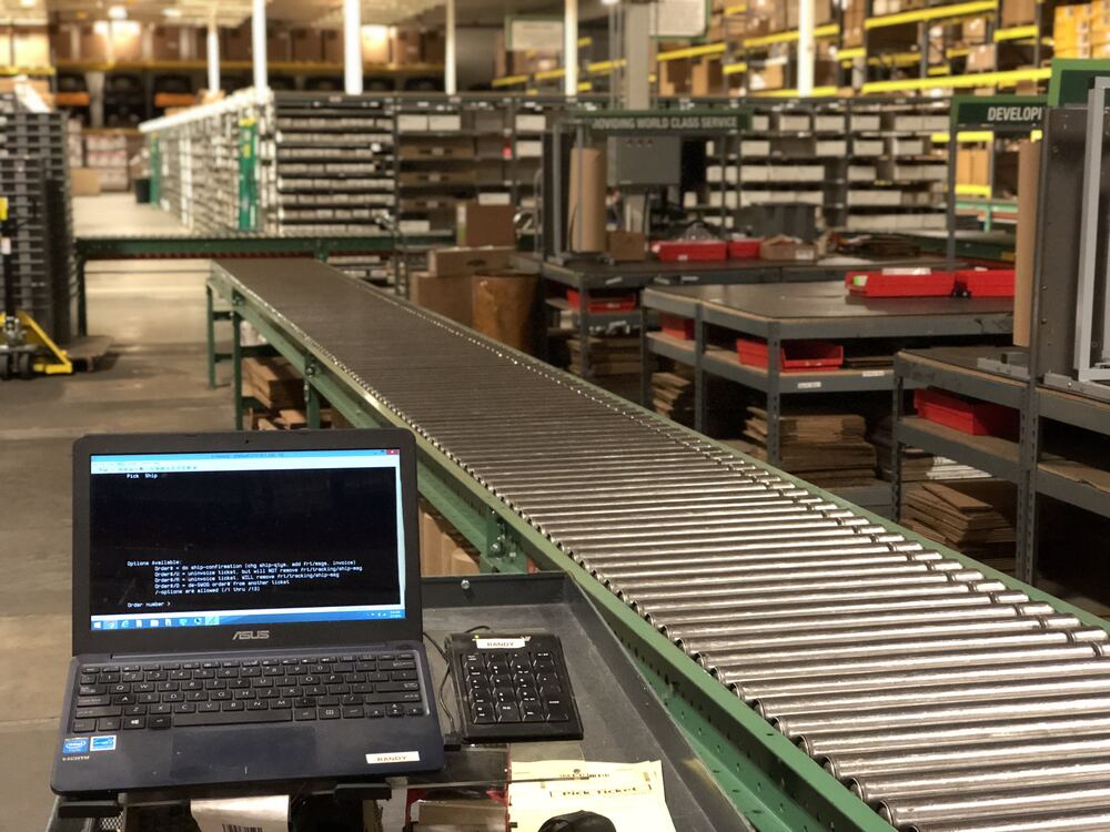 On-site project photo - laptop and warehouse terminal